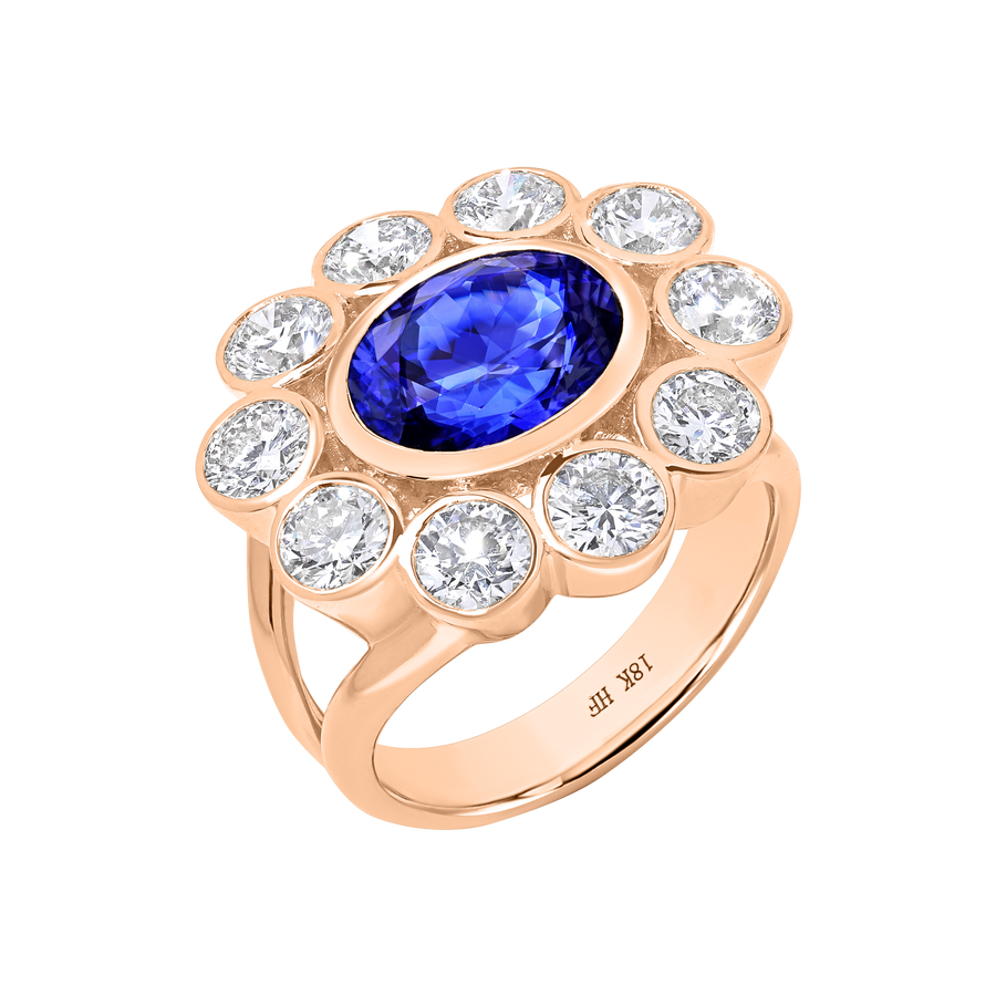 Rose gold ring with a blue gemstone and clear diamonds on a white background